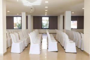 a row of white chairs in a waiting room at FAY Victoria Beach in Rincón de la Victoria