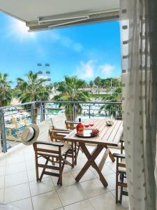 a balcony with a table and chairs and a view of the ocean at Mare Marina View 1 in Xylokastron