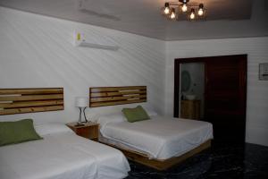 Postel nebo postele na pokoji v ubytování Hotel Samoa del Sur