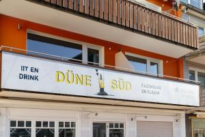 a sign for a dume sub on the side of a building at Helgolandia Dependance in Helgoland