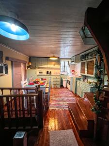 a kitchen with wooden floors and a table in it at DandyVillas-Vintage Cottage House-Pelion-Argalasti-Kallithea in KallithÃ©a