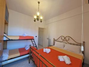 a bedroom with two bunk beds and a chandelier at [Loano Centro] Vista aperta nel cuore del Paese in Loano