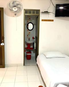 Postel nebo postele na pokoji v ubytování Hotel Mi Casita Pereira