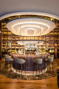 a bar in a restaurant with a large chandelier at SANA Malhoa Hotel in Lisbon