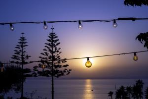 a string of lights in front of the ocean at La Meridiana in Capo Vaticano