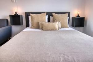 a bedroom with a large bed with two lamps on it at Phaedrus Living: Seaside Luxury Flat Athina 117 in Paphos