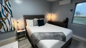 a bedroom with a large bed and a window at Oceano Suites Daytona Beach in Daytona Beach