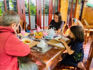 a group of people sitting at a table eating food at Wood Heart in Ella