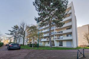 samochód zaparkowany przed budynkiem w obiekcie Aux portes de Paris , un 3 pcs bien aménagé w mieście Nogent-sur-Marne