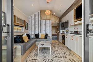 uma sala de estar com um sofá e uma mesa numa cozinha em The Escape - Luxury Pod Close to Beach em Amroth