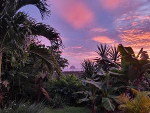 a sunset view from the garden of a house at Ti coin de paradis Ylang Ylang in Le Diamant