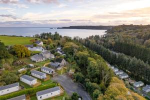 an aerial view of a farm with a lake at The Escape - Luxury Pod Close to Beach in Amroth