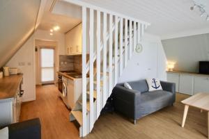 a living room with a couch and a stair case at Kingsdown Chalet No.5 in Kingsdown