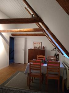 a dining room with a table and chairs in a attic at HosHelle in Ribe