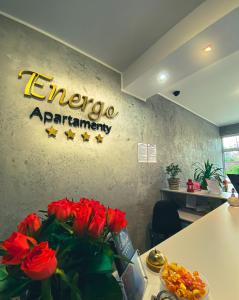 an office with a sign on the wall with red roses at Apartamenty Energo in Bytom
