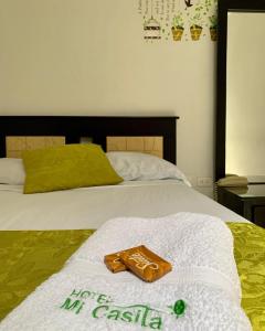 a hotel room with two towels on a bed at Hotel Mi Casita Pereira in Pereira