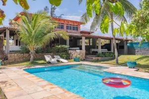 a villa with a swimming pool and a house at Casa Dunas - Espaço e Conforto em PDD by Carpediem in Aquiraz