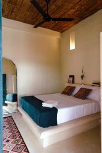 a bedroom with a large bed with a ceiling at Casa De Amigos Hotel Boutique in Honda