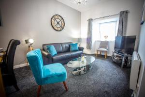 a living room with a couch and a table at Douglas House Apartments in Nairn
