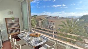 einen Balkon mit einem Tisch und Stadtblick in der Unterkunft Les Dauphins in Sainte-Maxime