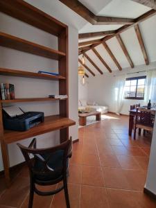 a living room with a chair and a table at Surf&fun heated pool villa in La Oliva
