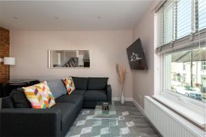 a living room with a couch and a window at Work Trips Refined in Gillingham