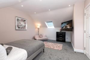 a bedroom with a bed and a flat screen tv at Work Trips Refined - Comfort and Productivity in Gillingham