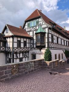 a building with a clock on the side of it at Casa „Ella“ in Friedrichroda