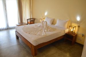 Voodi või voodid majutusasutuse Giman Free Beach Resort toas