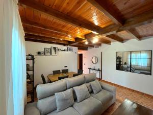 a living room with a couch and a table at Chalet El Parral - Piscina y Sala de Cine in Málaga