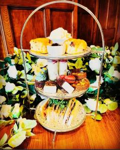 a three tiered display of desserts and pastries on a table at Burythorpe House in Malton