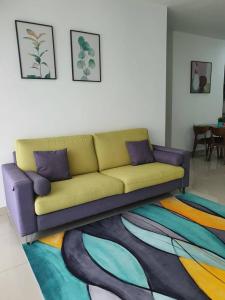 a couch in a living room with a colorful rug at SYG 4 Dwiputra Homestay Putrajaya 3 Bilik Tidur in Putrajaya