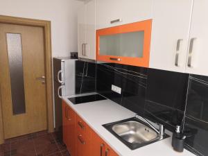 a kitchen with a sink and a microwave at Apartman Deni in Travnik