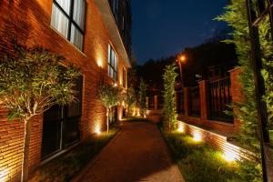 a walkway in front of a brick building at night at Address Boutique Hotel in Tbilisi City