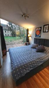 a bedroom with a bed with a blue blanket on it at Domek Hrabiny nr 3 in Rozkochów