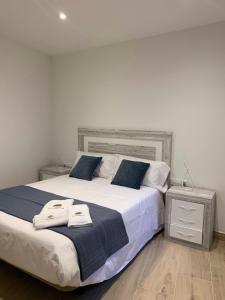 a bedroom with a large bed with two towels on it at Ca La Rosalia Arbeca in Arbeca