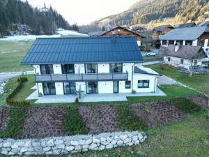 an aerial view of a house with a black roof at Ferienwohnungen Bergpanorama in Bad Mitterndorf +20 photos
