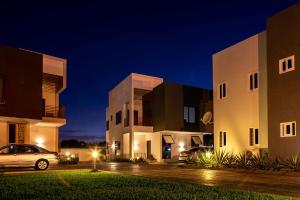 a car parked in front of a building at night at Green Court Serviced Apartments in Accra