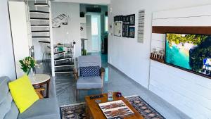 a living room with a tv and a couch and a table at Iason Seaview home in Latchi in Polis Chrysochous