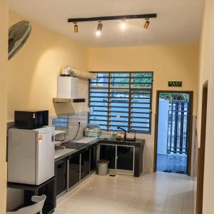 a kitchen with a sink and a refrigerator at Viens303 Home Bentong Homestay in Bentong