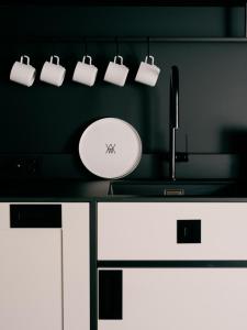 a bathroom counter with a sink and a mirror at WELTWIEN Luxury Art Apartments in Vienna