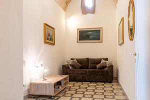 a living room with a couch and a table at WePuglia - Catarì in Polignano a Mare