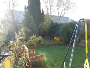 a garden with two chairs in a yard at Beautiful family home in Taffs Well