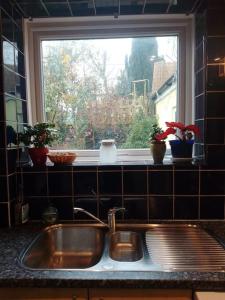 a sink in a kitchen with a window at Beautiful family home in Taffs Well