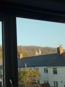 a window with a view of a white building at Beautiful family home in Taffs Well +5 photos