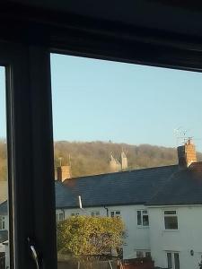 a window with a view of a white building at Beautiful family home in Taffs Well