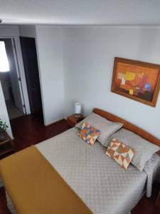a bedroom with a bed with two pillows on it at Departamento en centro de Viña del Mar in Viña del Mar