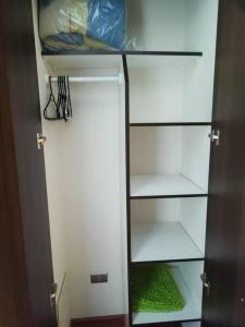 a white refrigerator with its door open with green inside at Departamento en centro de Viña del Mar in Viña del Mar