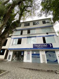 a building with aeliococo sign in front of it at Vivienda turística Arboleda de Cádiz in Ibagué