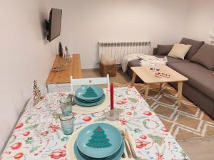 a living room with a table with a christmas tree on it at Apartamentos Playa de Finisterre in Fisterra